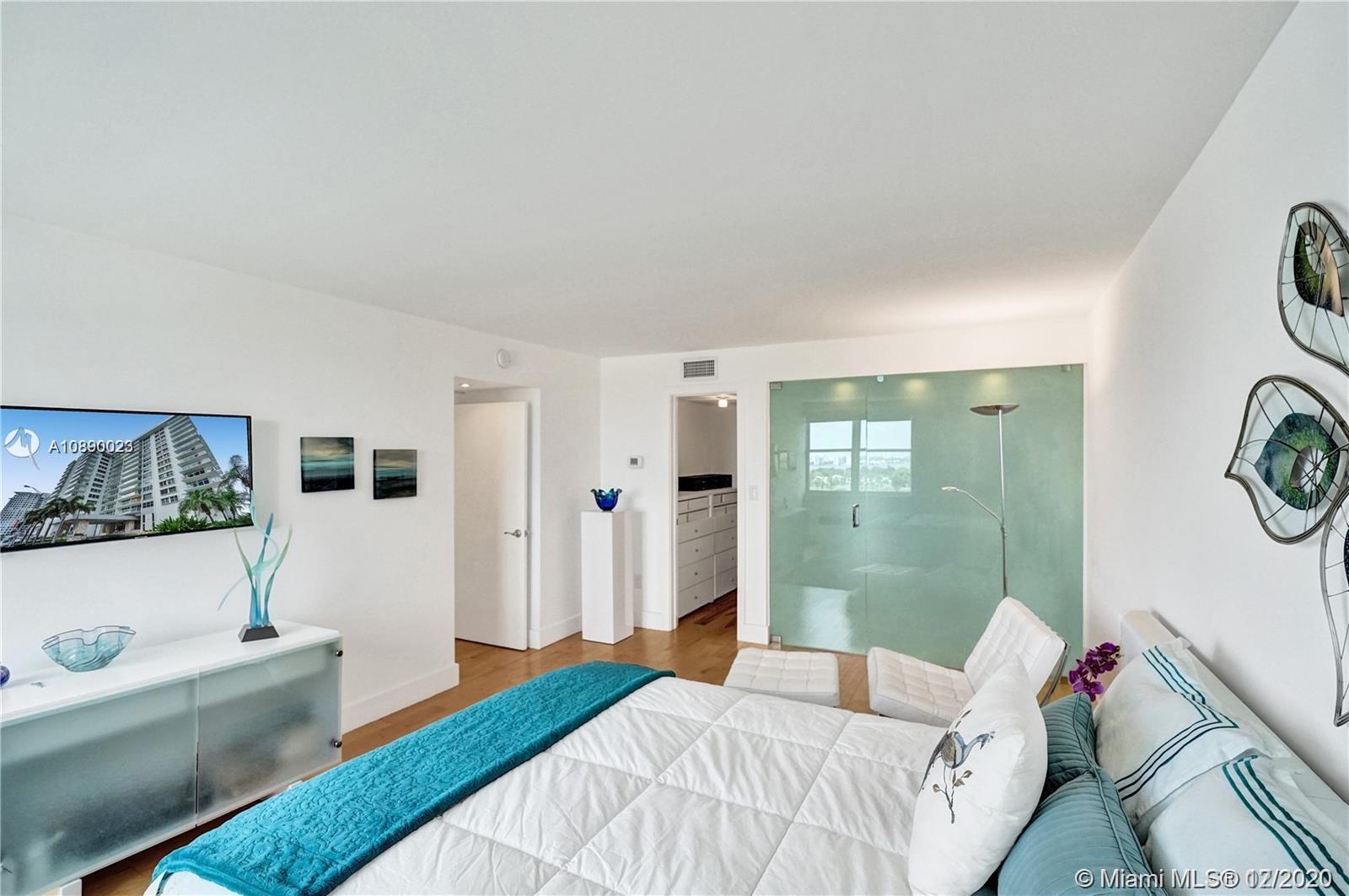 5750 Collins Avenue, Unit 15F Miami Beach, FL 33140 - Photo 36 of 65 a bedroom with a bed and a window
