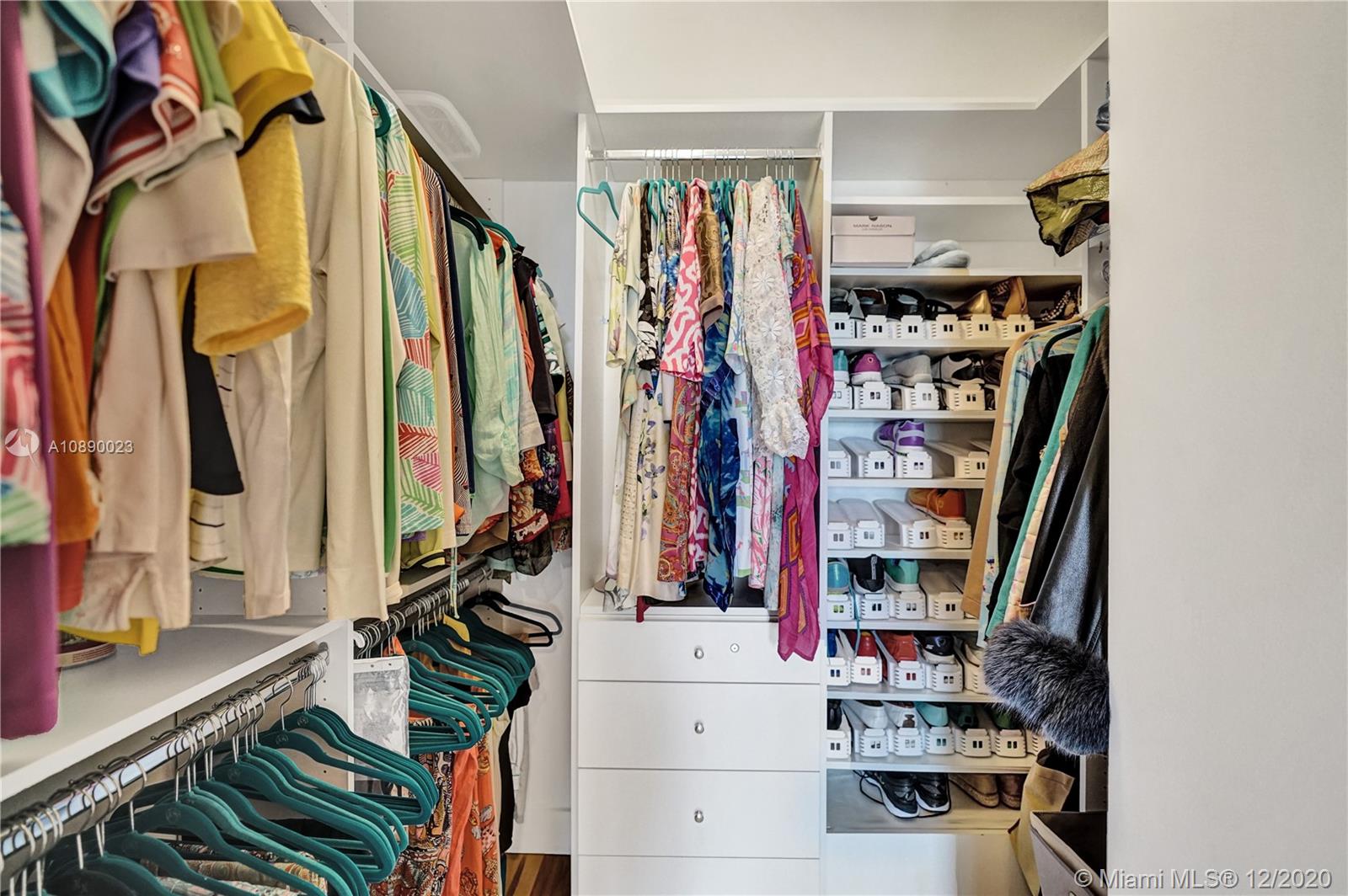 5750 Collins Avenue, Unit 15F Miami Beach, FL 33140 - Photo 38 of 65 a view of walk in closet with clothes and shoes