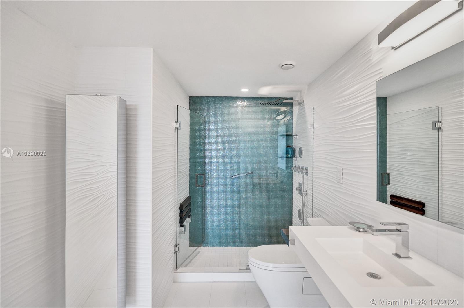 5750 Collins Avenue, Unit 15F Miami Beach, FL 33140 - Photo 41 of 65 a bathroom with a sink toilet and shower