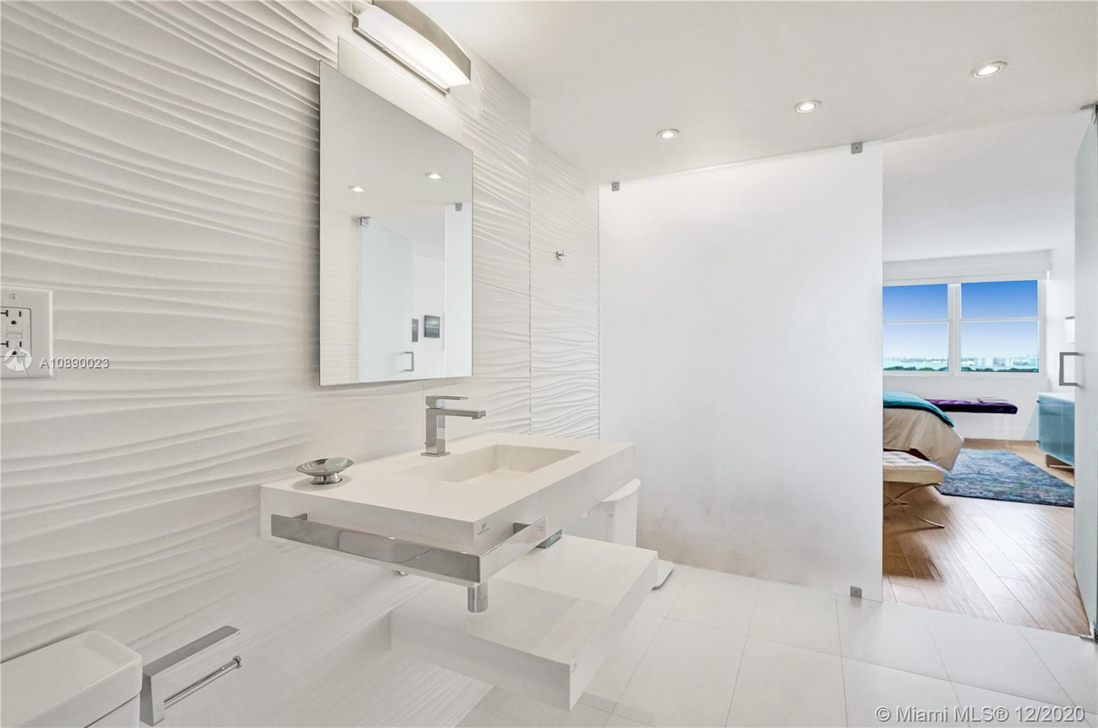 5750 Collins Avenue, Unit 15F Miami Beach, FL 33140 - Photo 43 of 65 a bathroom with a sink and a mirror