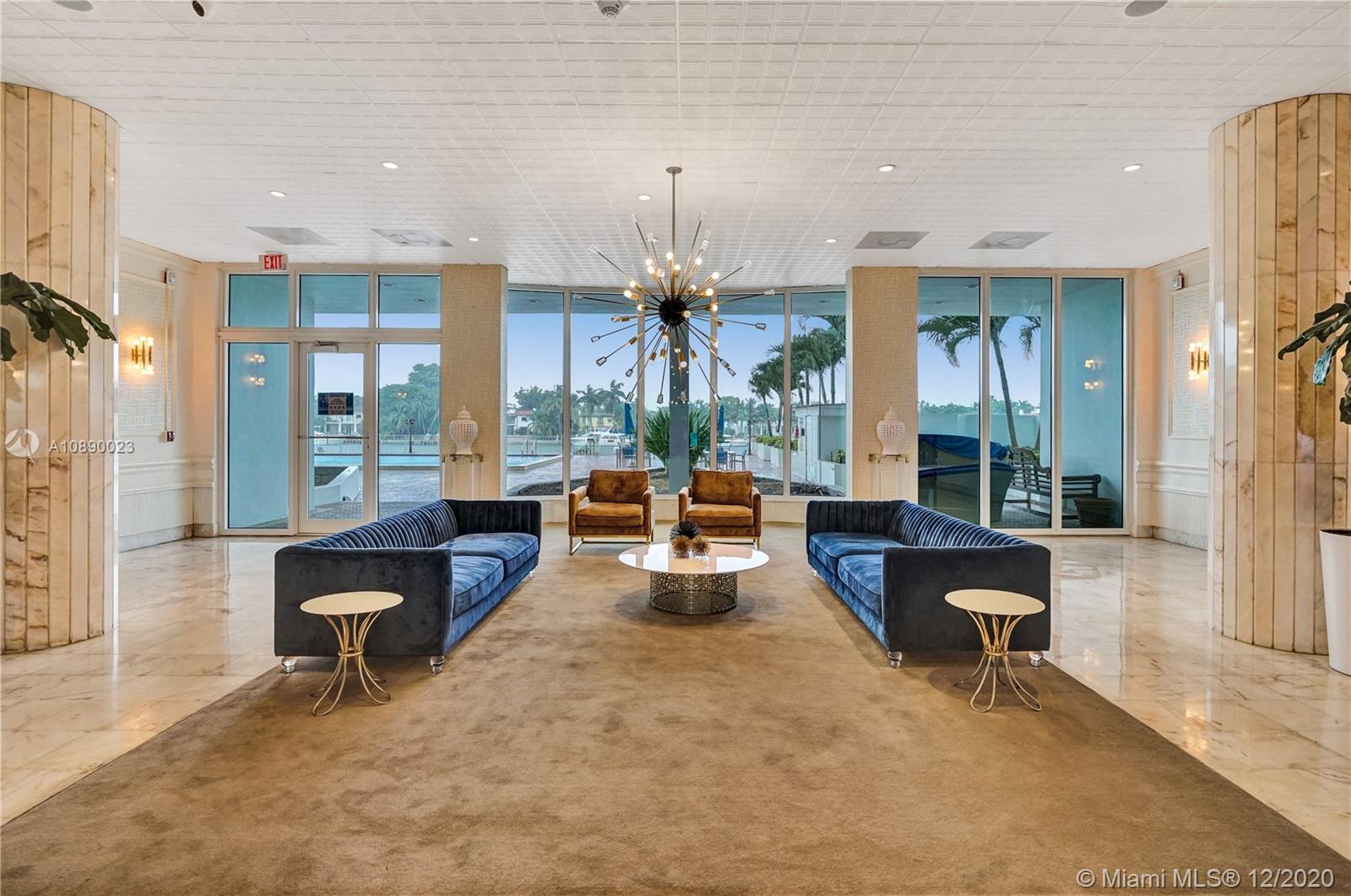 5750 Collins Avenue, Unit 15F Miami Beach, FL 33140 - Photo 55 of 65 a living room with furniture and a chandelier