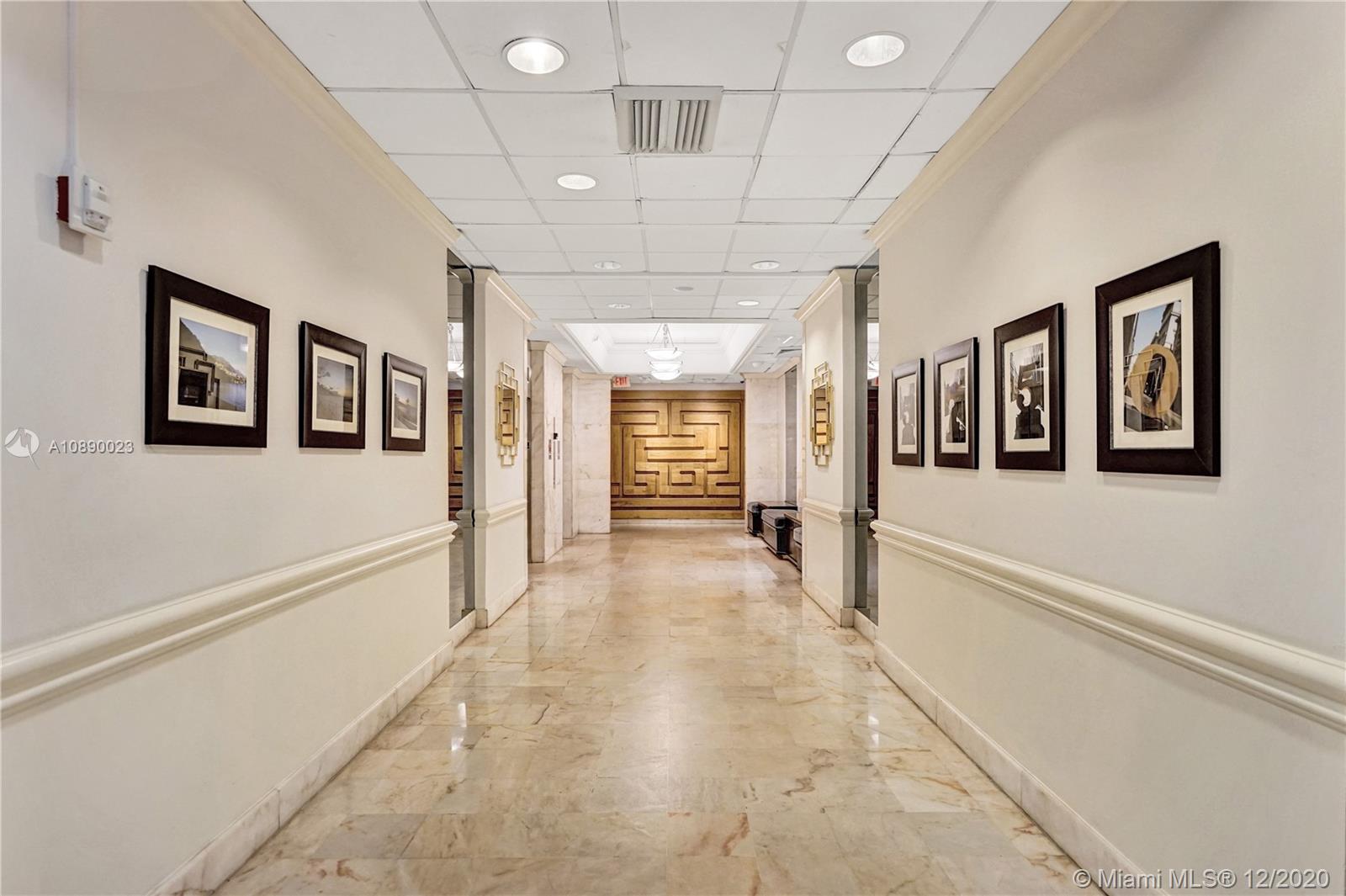 5750 Collins Avenue, Unit 15F Miami Beach, FL 33140 - Photo 57 of 65 a view of a hallway with wooden floor and windows