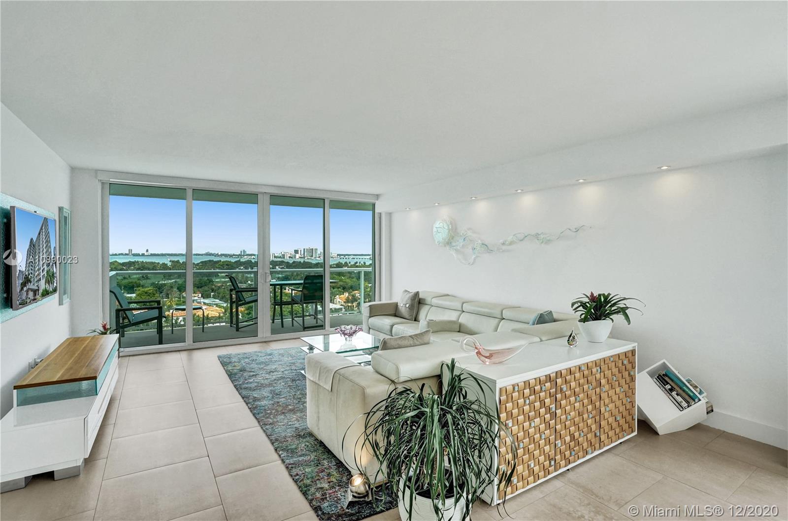5750 Collins Avenue, Unit 15F Miami Beach, FL 33140 - Photo 7 of 65 a living room with furniture and a large window