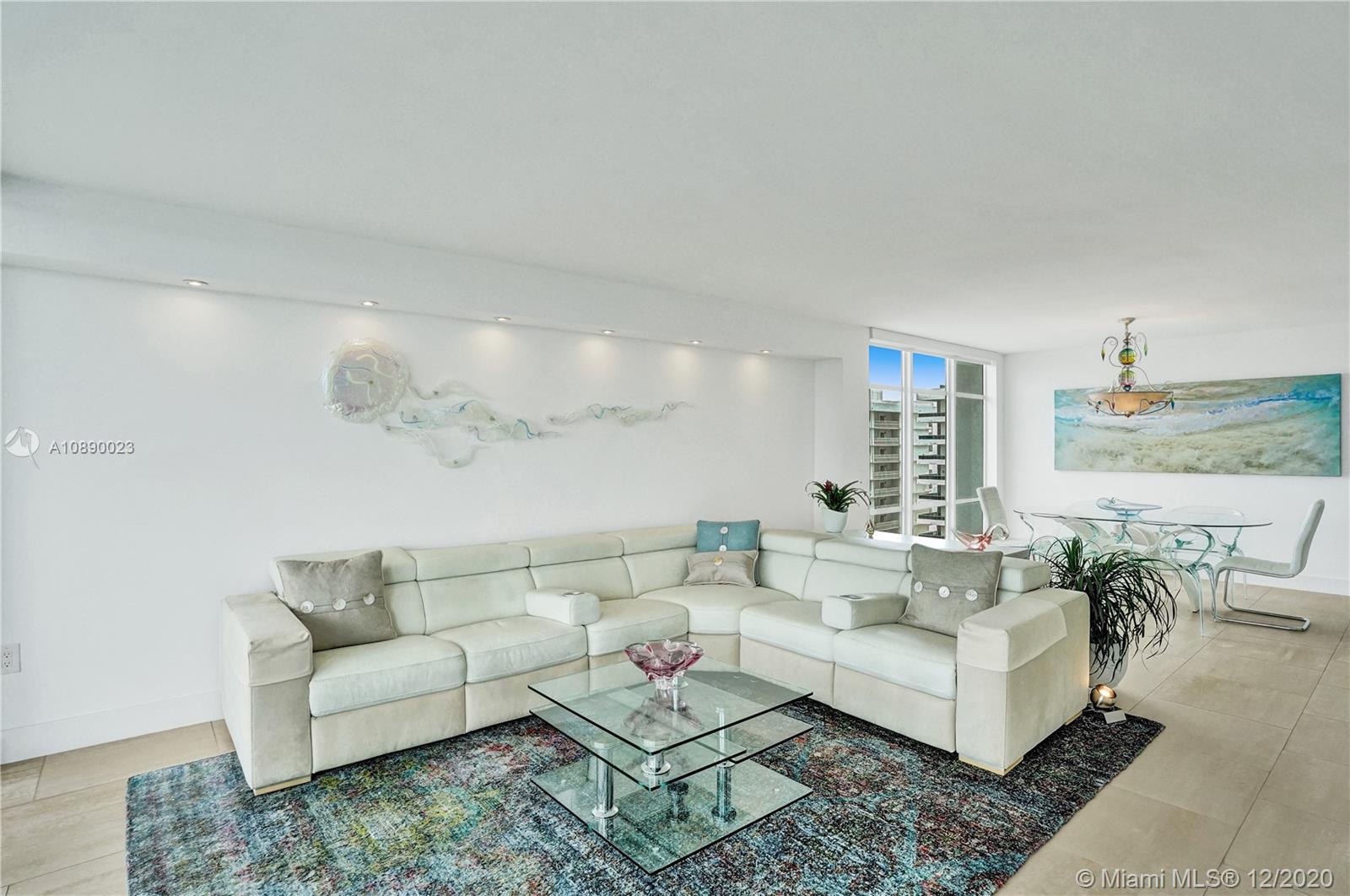 5750 Collins Avenue, Unit 15F Miami Beach, FL 33140 - Photo 10 of 65 a living room with furniture and a table