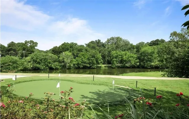 a view of a tennis ground with large trees