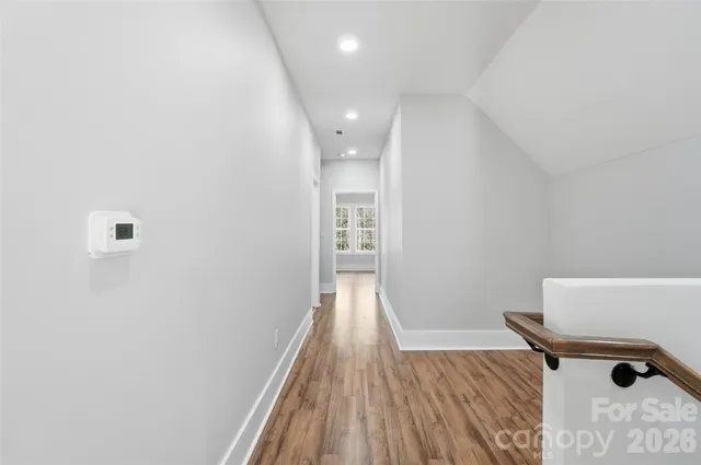 a view of hallway with wooden floor