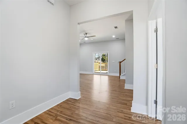 a view of a hallway with wooden floor