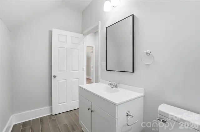 a bathroom with 2 sink and a mirror