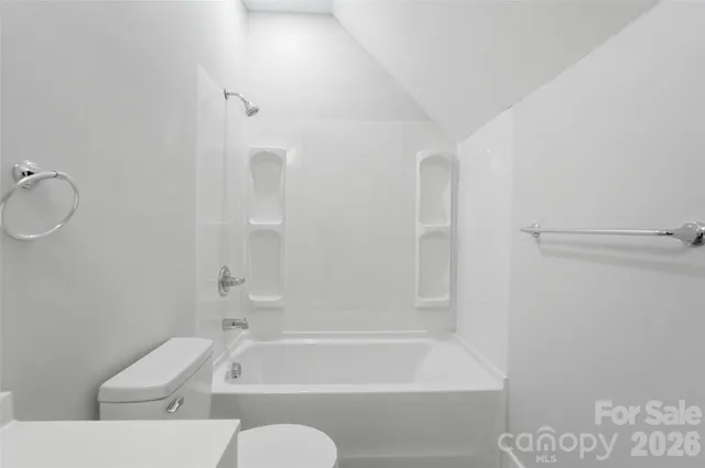 a bathroom with a toilet bathtub and shower