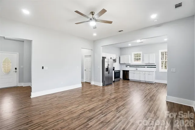 a view of a kitchen with a sink and a refrigerator