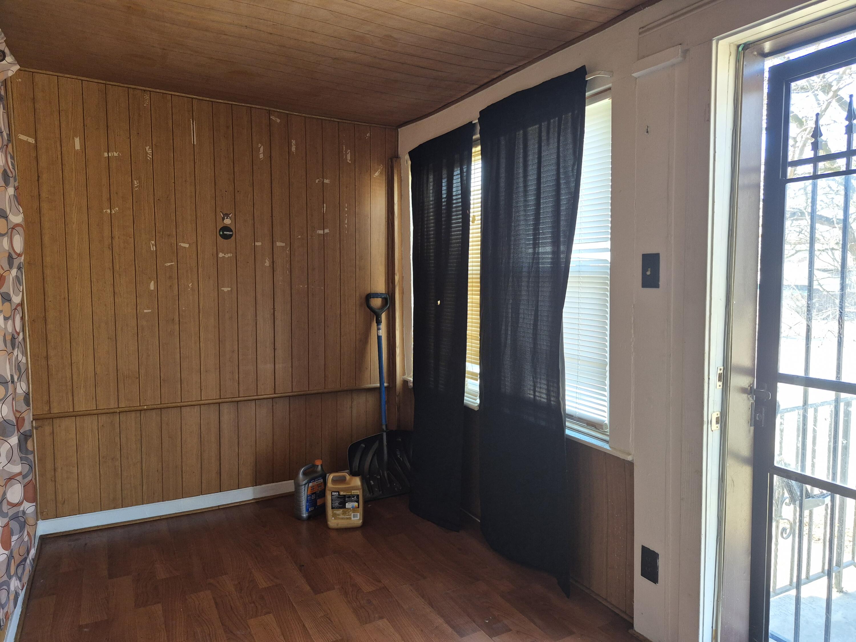 395 Porter Street Gary, IN 46406 - Photo 3 of 14 an empty room with wooden floor and a window