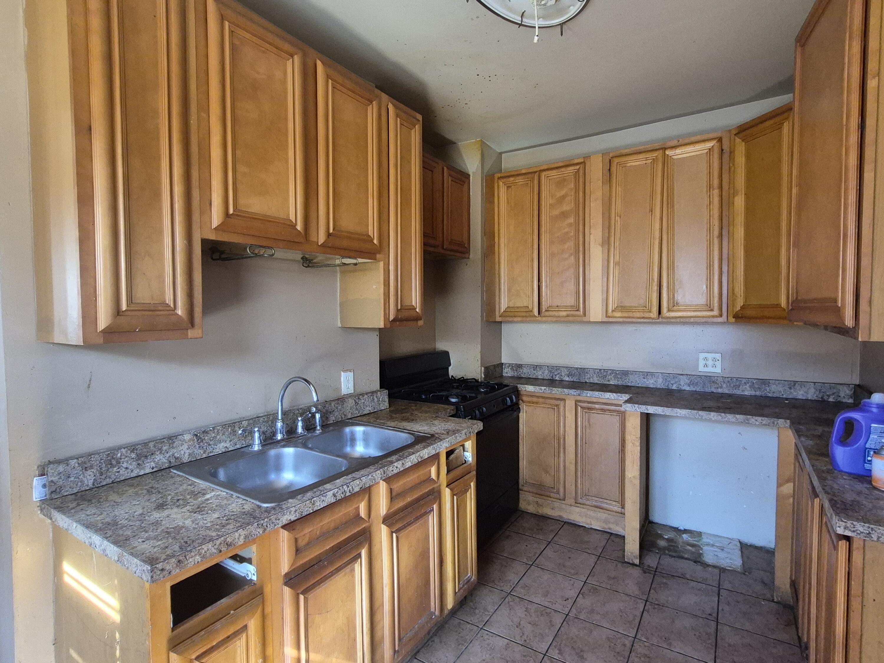 395 Porter Street Gary, IN 46406 - Photo 6 of 14 a kitchen with stainless steel appliances granite countertop sink stove and cabinets