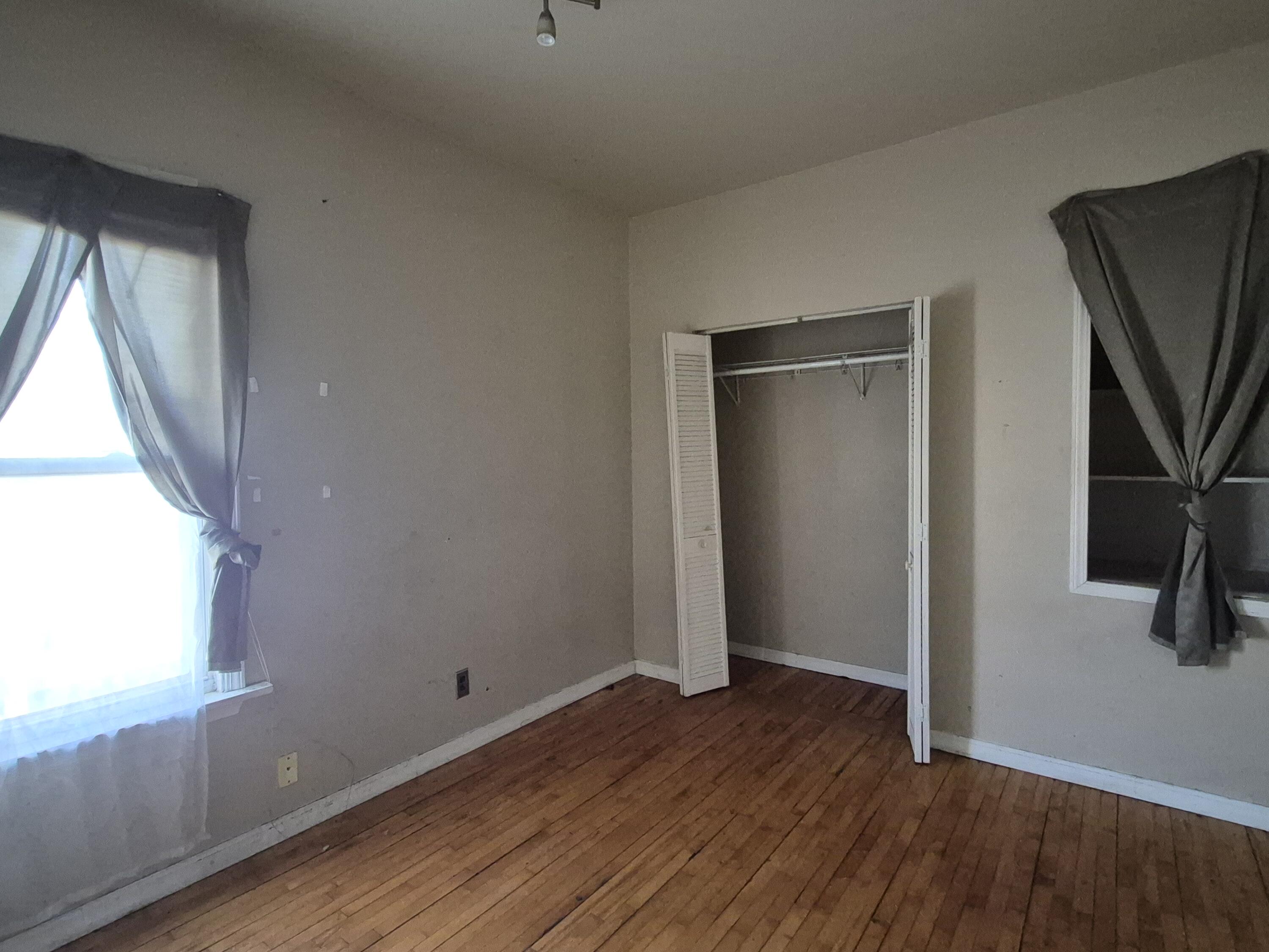 395 Porter Street Gary, IN 46406 - Photo 7 of 14 a view of a livingroom with wooden floor and a window