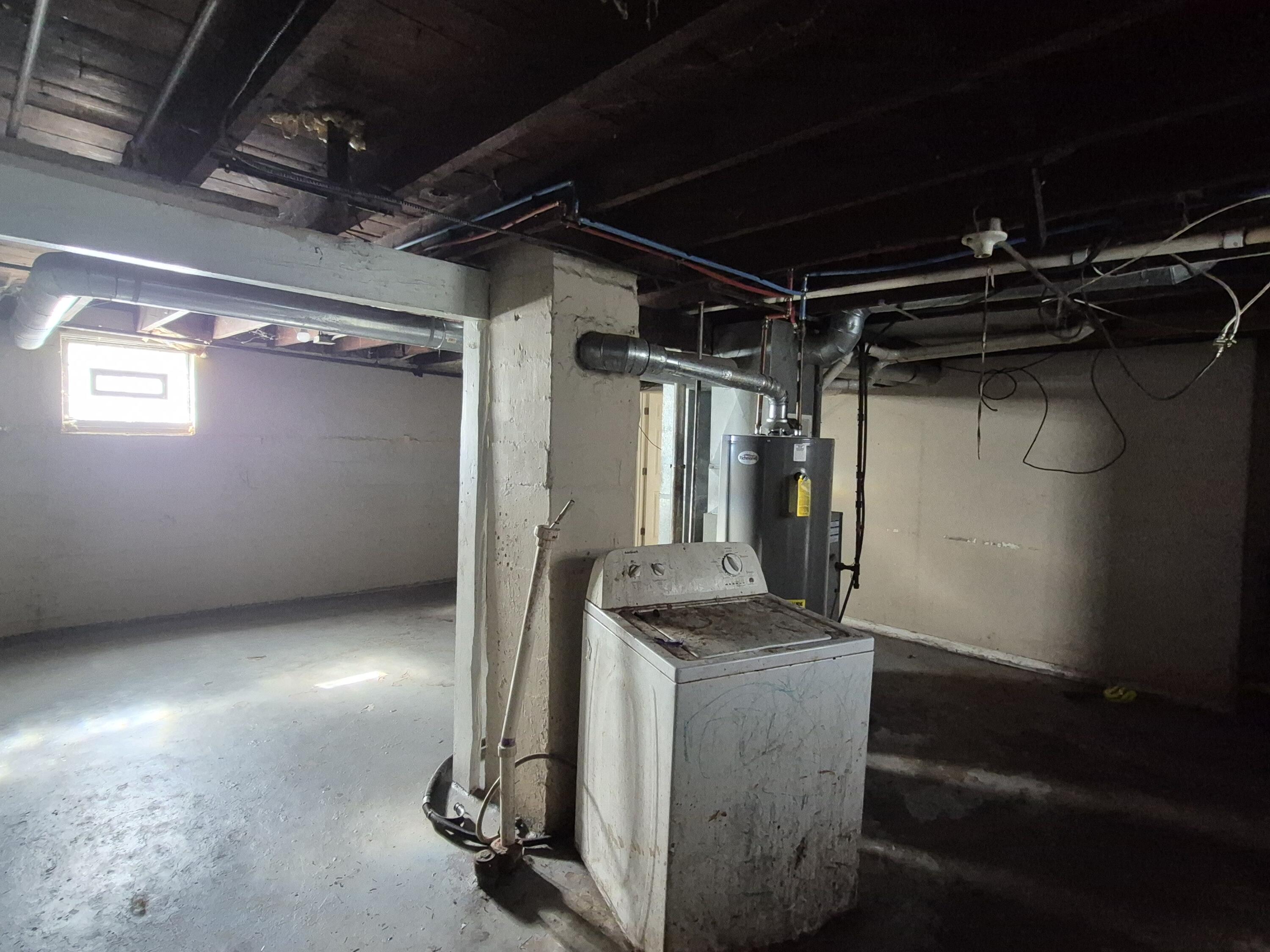 395 Porter Street Gary, IN 46406 - Photo 9 of 14 a room with water heater and wooden cabinets