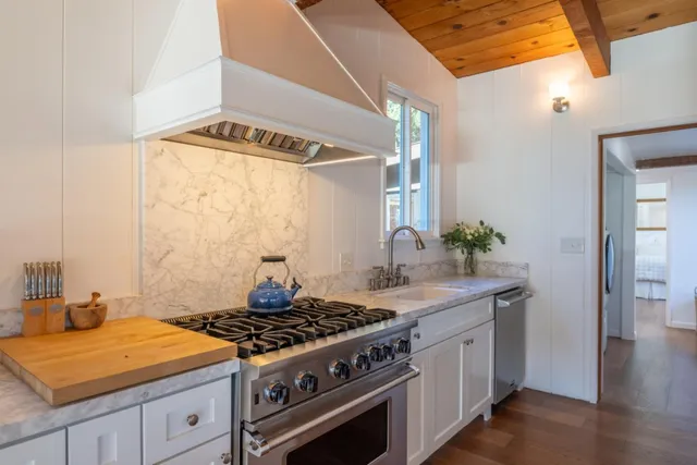 a living room filled with furniture and potted plants