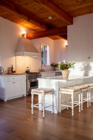 a bedroom with a large bed and a view of living room