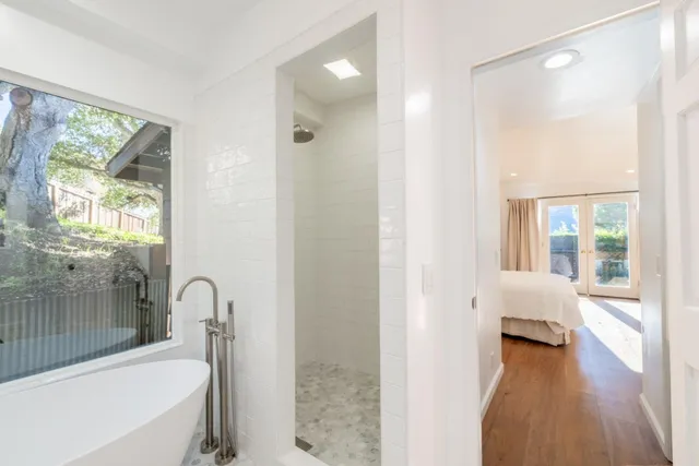a view of a patio with table and chairs under an umbrella