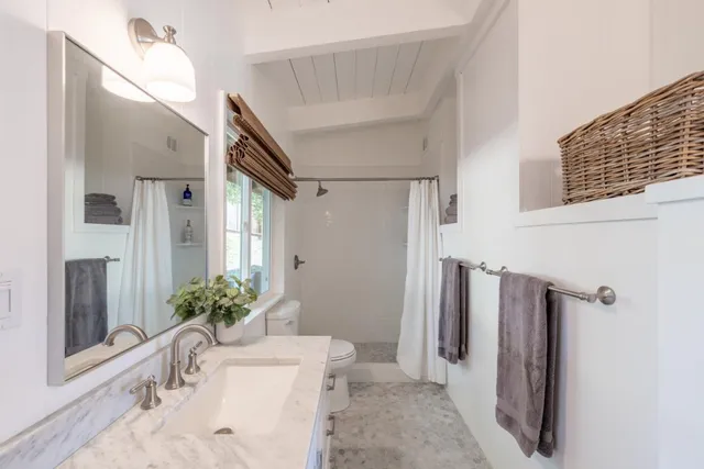 a view of a patio with table and chairs floor to ceiling window with wooden fence