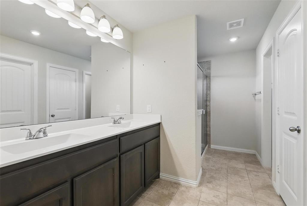 240 Springwood Ranch Loop Springtown, TX 76082 - Photo 14 of 27 a bathroom with a double vanity sink and a mirror