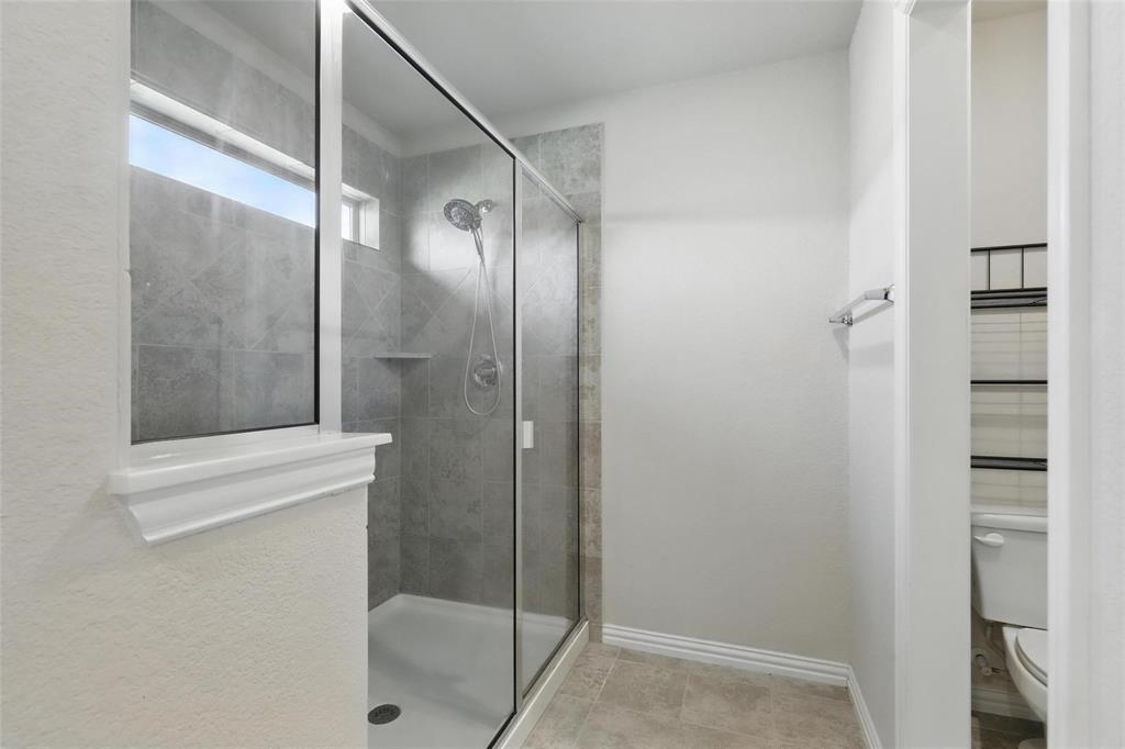 240 Springwood Ranch Loop Springtown, TX 76082 - Photo 15 of 27 a bathroom with a glass shower door