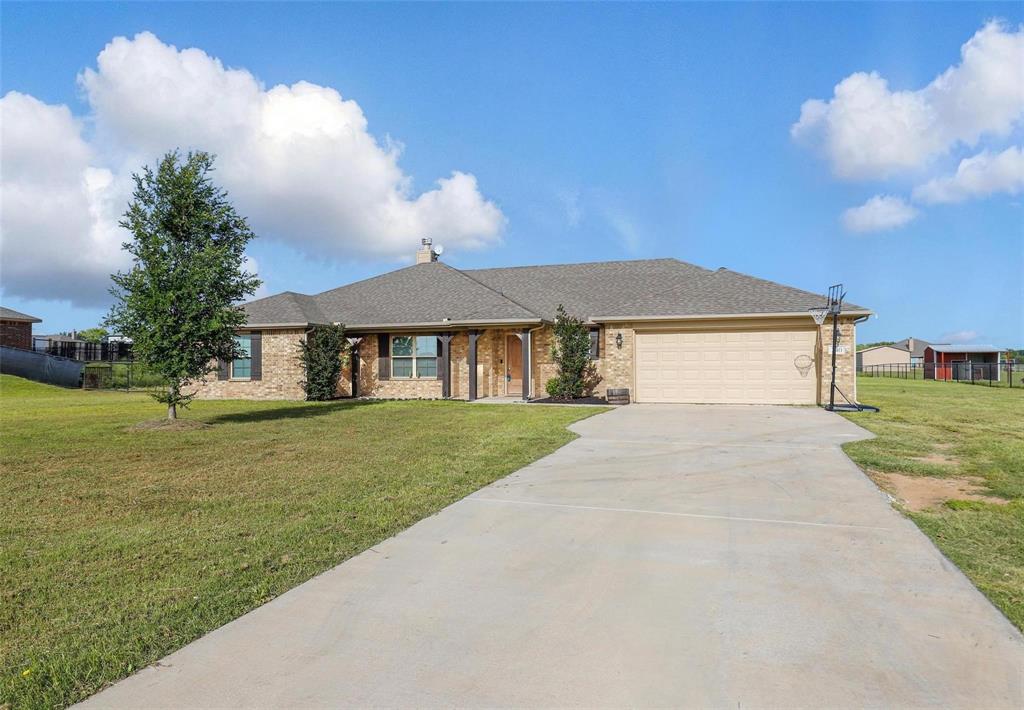 240 Springwood Ranch Loop Springtown, TX 76082 - Photo 2 of 27 a front view of a house with garden