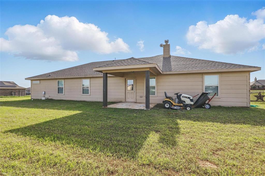 240 Springwood Ranch Loop Springtown, TX 76082 - Photo 24 of 27 a view of a house with backyard