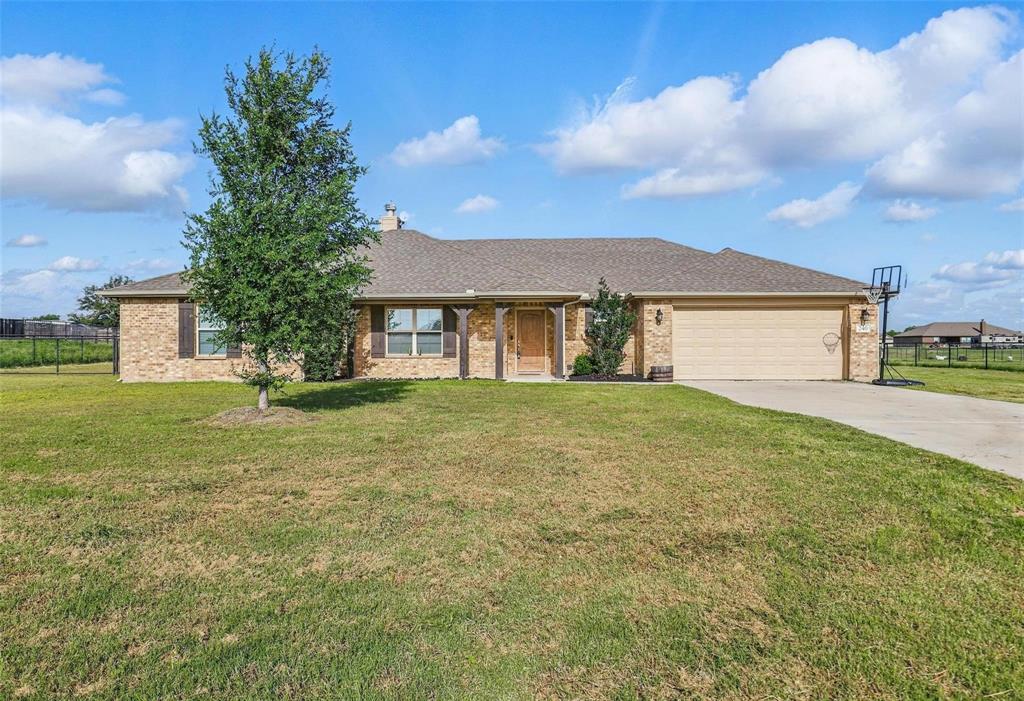 240 Springwood Ranch Loop Springtown, TX 76082 - Photo 27 of 27 a front view of a house with a garden