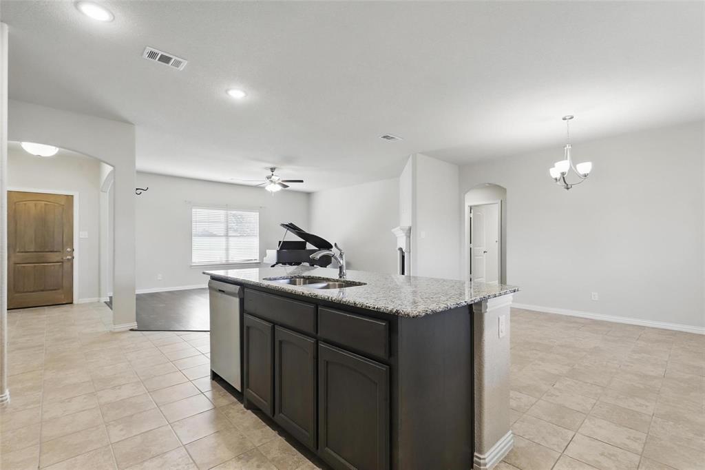 240 Springwood Ranch Loop Springtown, TX 76082 - Photo 6 of 27 a kitchen with stainless steel appliances granite countertop a sink and a refrigerator