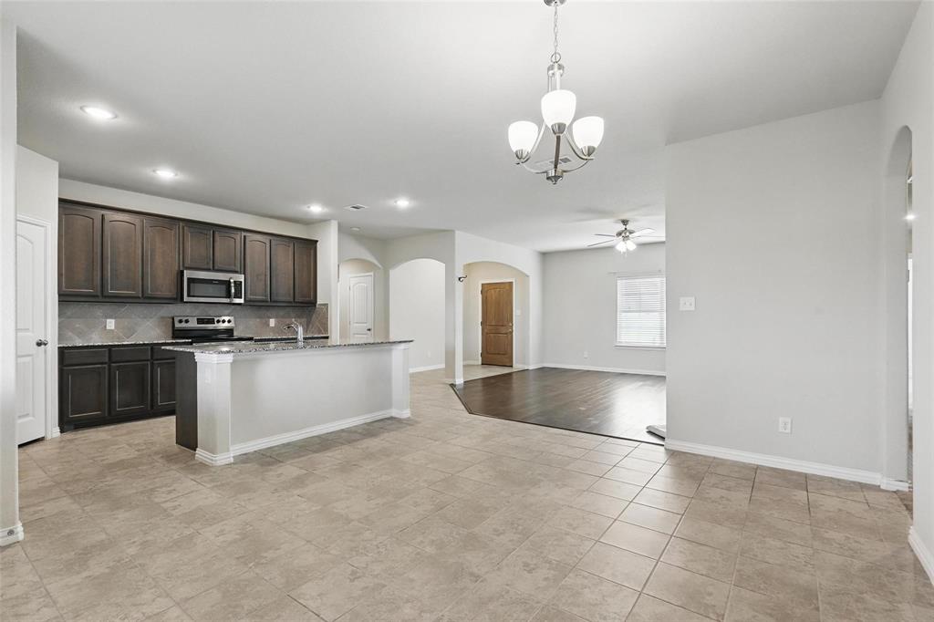 240 Springwood Ranch Loop Springtown, TX 76082 - Photo 10 of 27 a large kitchen with kitchen island a sink stainless steel appliances and cabinets