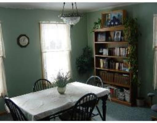 823 Orange Road Warwick, MA 01378 - Photo 5 of 8 a view of a dining room with furniture and a book shelf