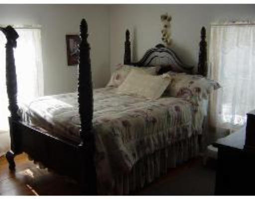 823 Orange Road Warwick, MA 01378 - Photo 6 of 8 a bed sitting in a bedroom next to a window