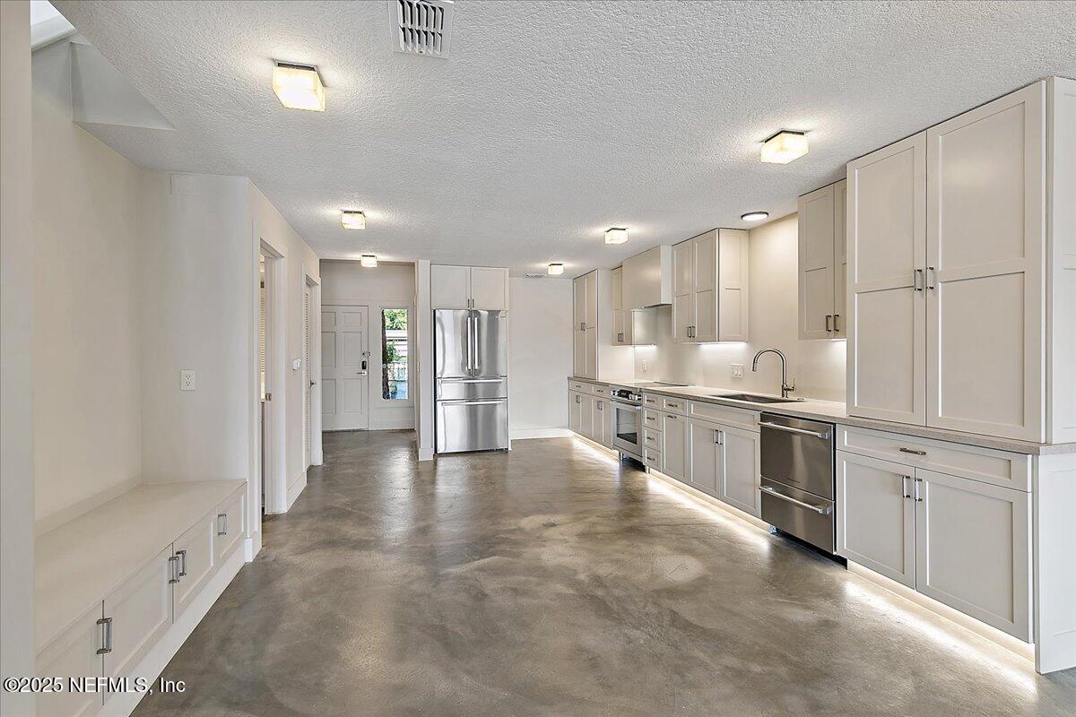 41 Fishermans Cove Road Ponte Vedra Beach, FL 32082 - Photo 13 of 36 a view of a kitchen with refrigerator and a sink