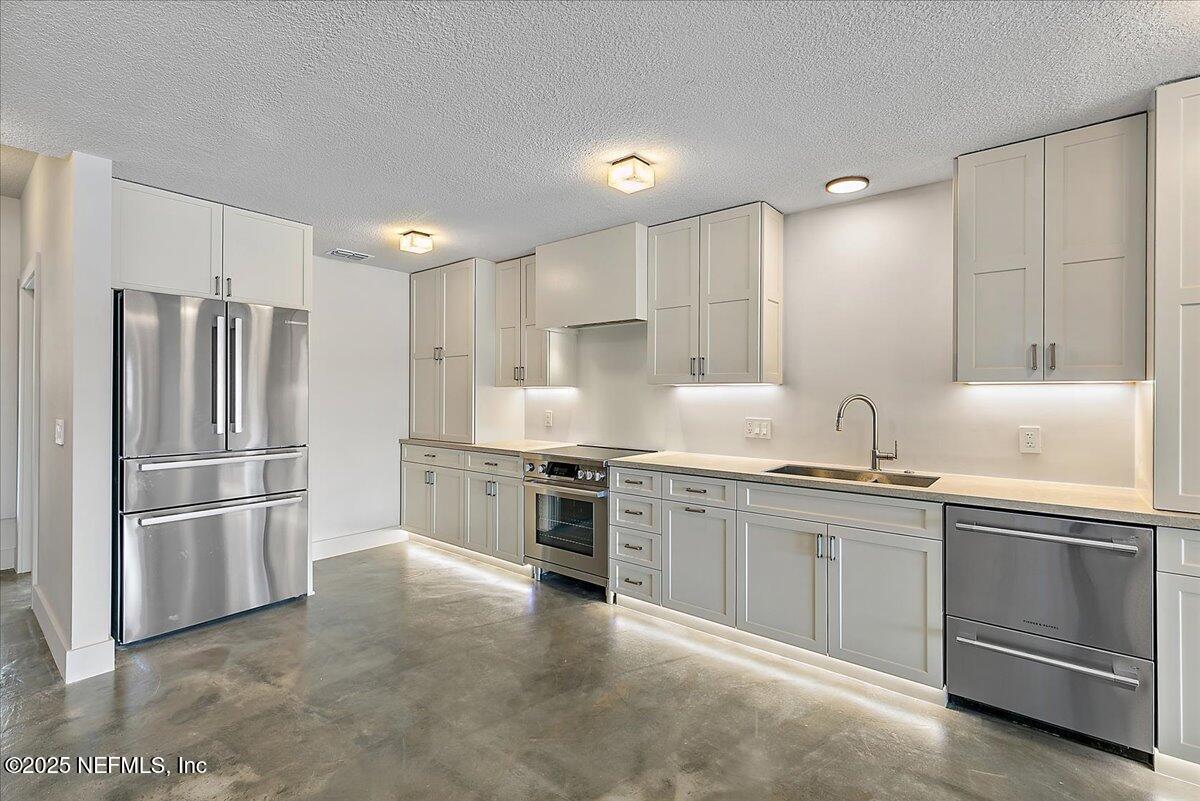 41 Fishermans Cove Road Ponte Vedra Beach, FL 32082 - Photo 14 of 36 a kitchen with stainless steel appliances granite countertop a refrigerator and a sink