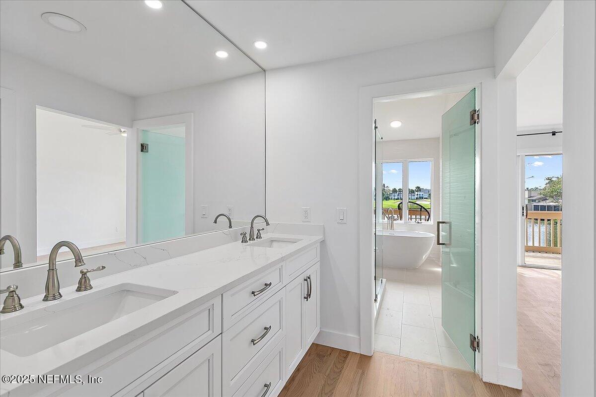 41 Fishermans Cove Road Ponte Vedra Beach, FL 32082 - Photo 26 of 36 a spacious bathroom with a shower sink and mirror