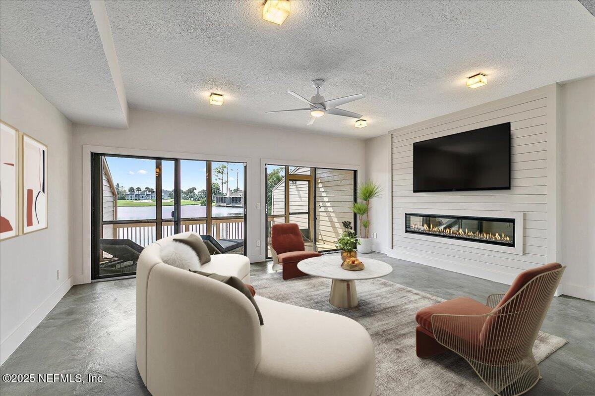 41 Fishermans Cove Road Ponte Vedra Beach, FL 32082 - Photo 5 of 36 a living room with furniture a flat screen tv and a large window
