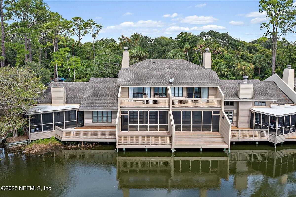 41 Fishermans Cove Road Ponte Vedra Beach, FL 32082 - Photo 8 of 36 a view of a lake with a house and a yard
