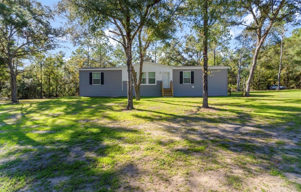 7990 Northeast 121 Street Bronson, FL 32621 - Photo 1 of 1 a view of a house with a yard