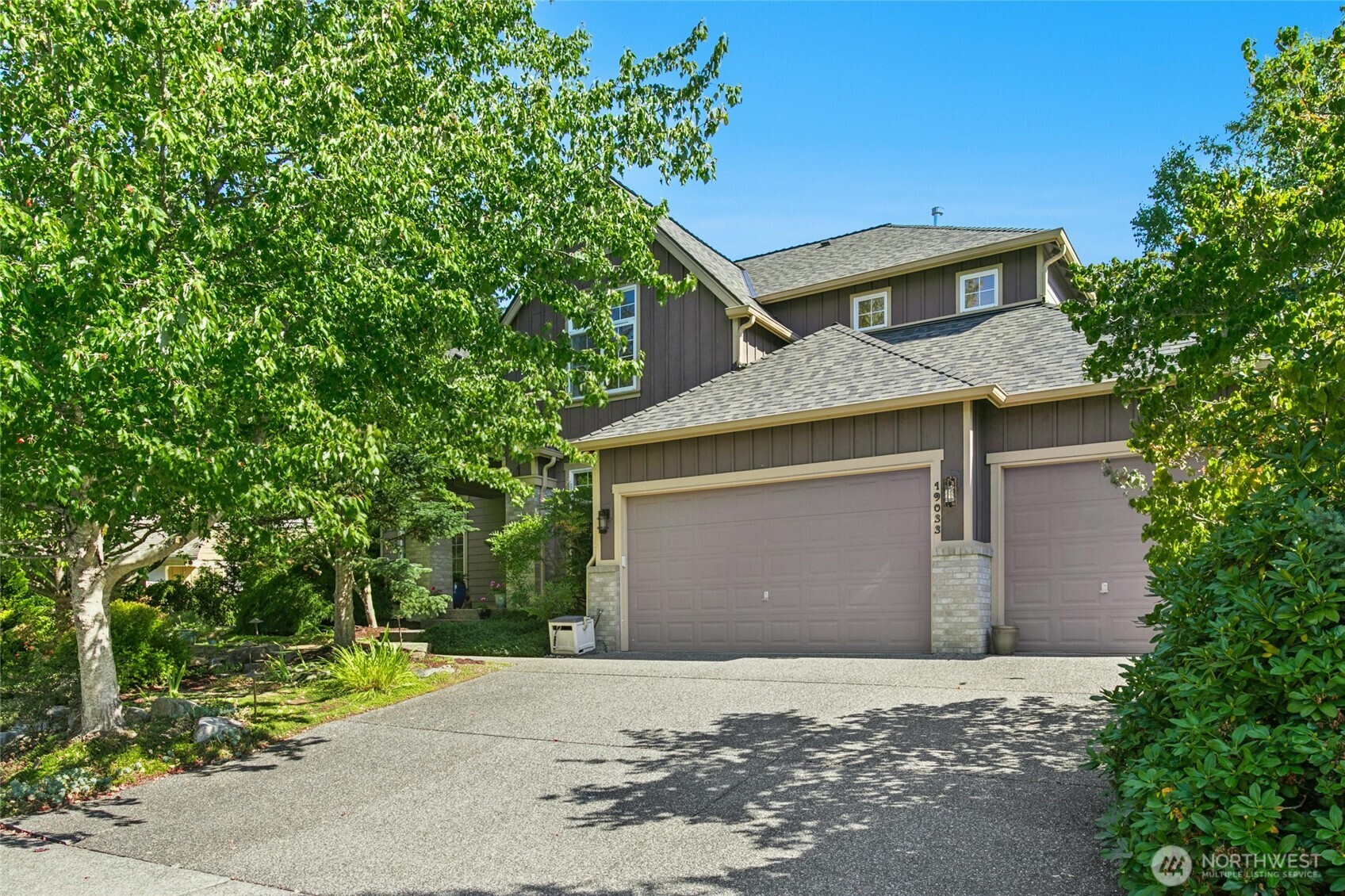 19033 29th Avenue Southeast Bothell, WA 98012 - Photo 1 of 40 a front view of a house with a yard and garage