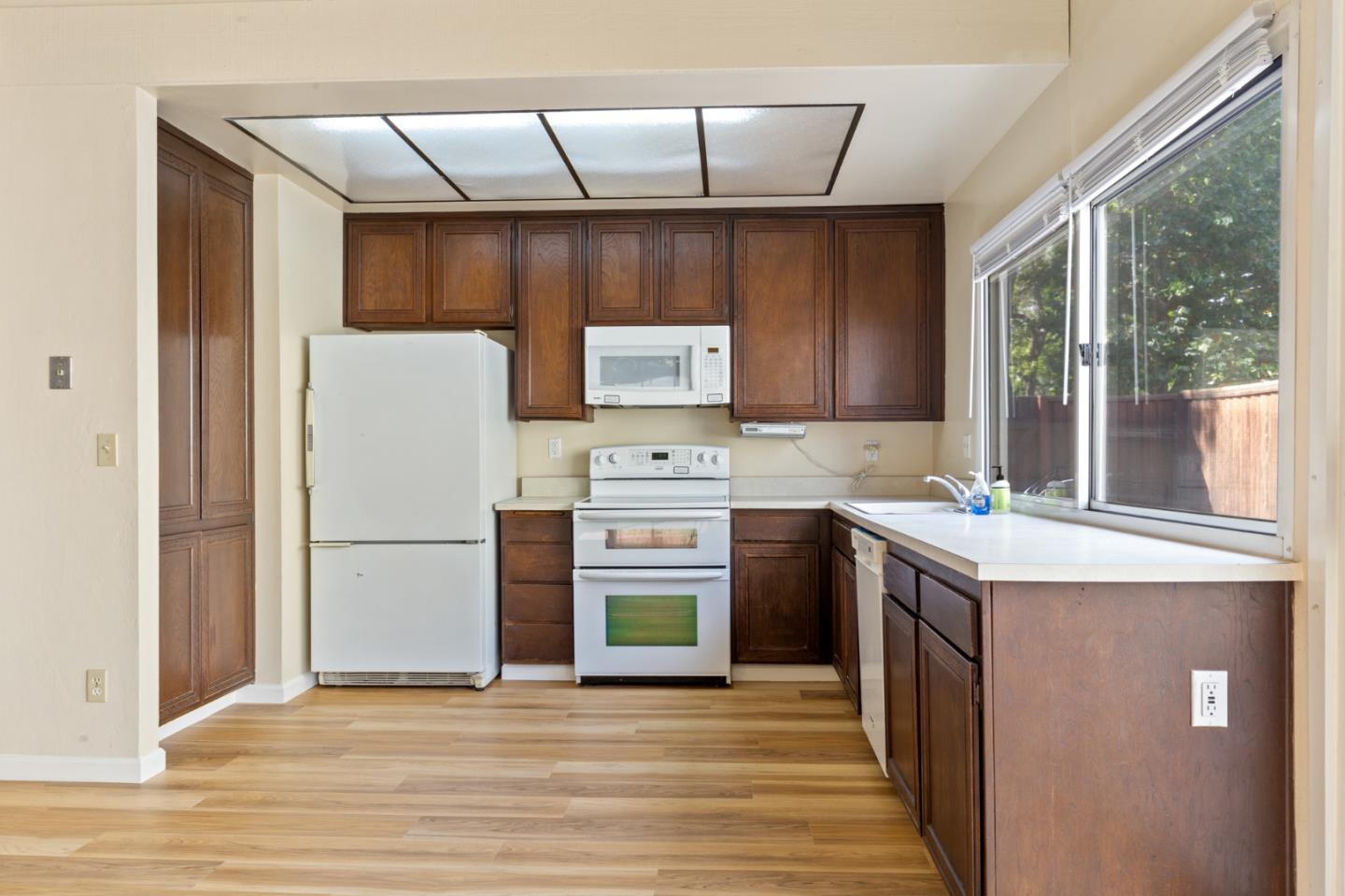 7034 Vía Pradera San Jose, CA 95139 - Photo 12 of 31 a kitchen with a stove top oven a sink and a refrigerator