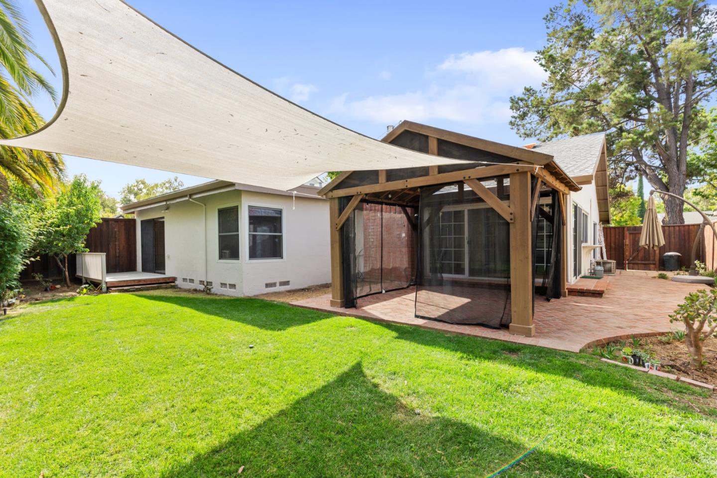 7034 Vía Pradera San Jose, CA 95139 - Photo 28 of 31 a view of a house with patio and a yard