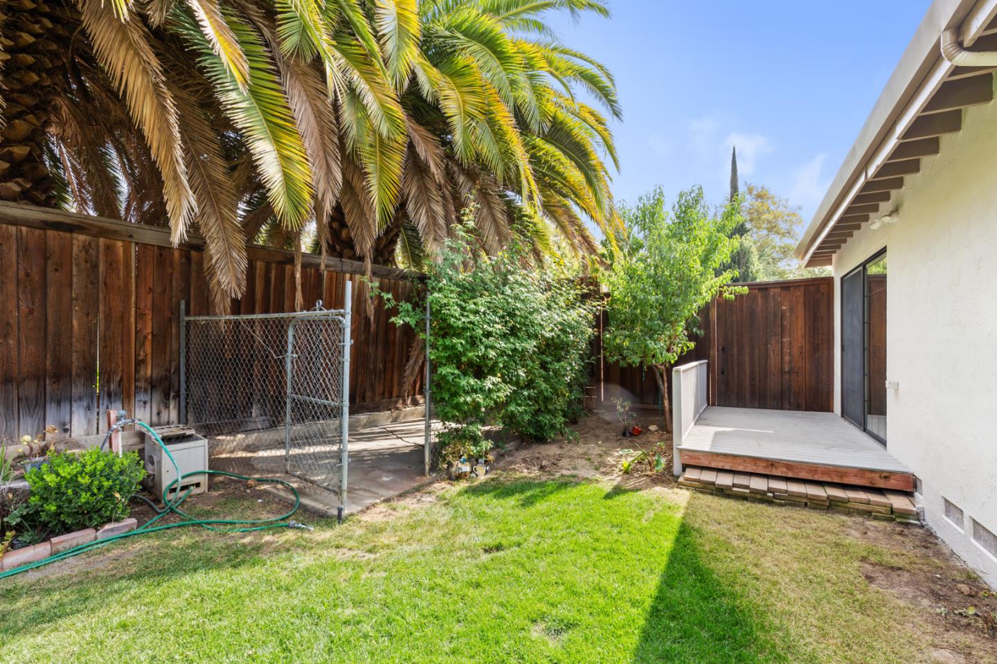 7034 Vía Pradera San Jose, CA 95139 - Photo 30 of 31 a view of a backyard with wooden fence and a bench