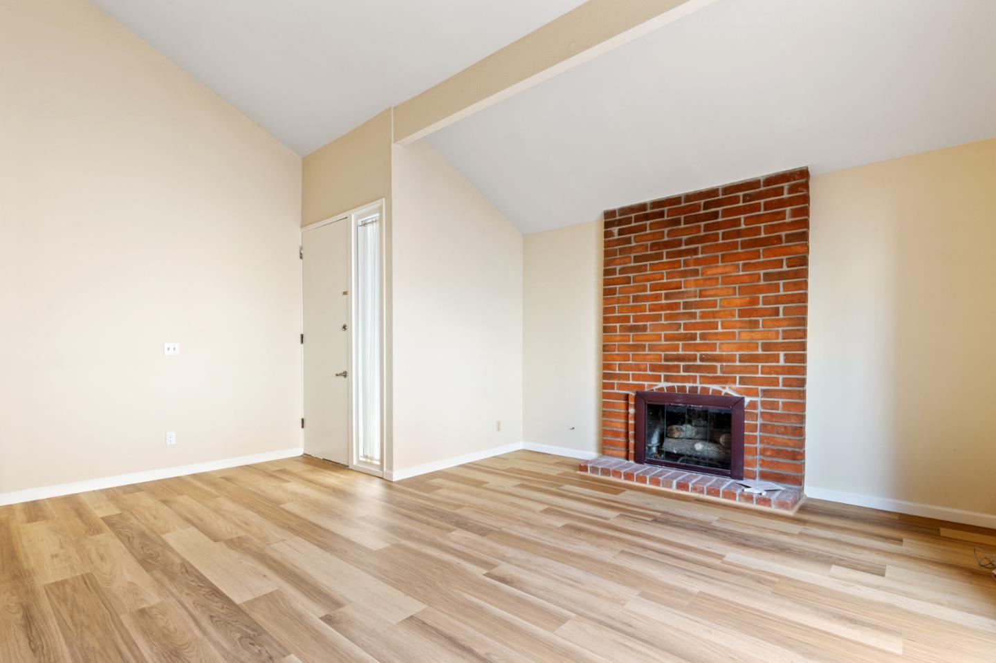 7034 Vía Pradera San Jose, CA 95139 - Photo 7 of 31 a view of empty room with wooden floor and fireplace