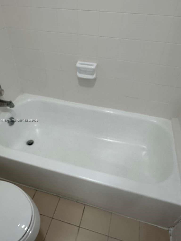 7355 West 4th Avenue, Unit 216 Hialeah, FL 33014 - Photo 2 of 7 a bathroom with a bathtub