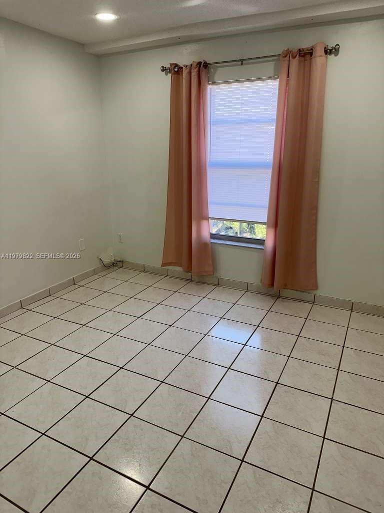 7355 West 4th Avenue, Unit 216 Hialeah, FL 33014 - Photo 5 of 7 a view of an empty room and window