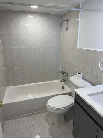 a bathroom with a toilet a sink and bathtub