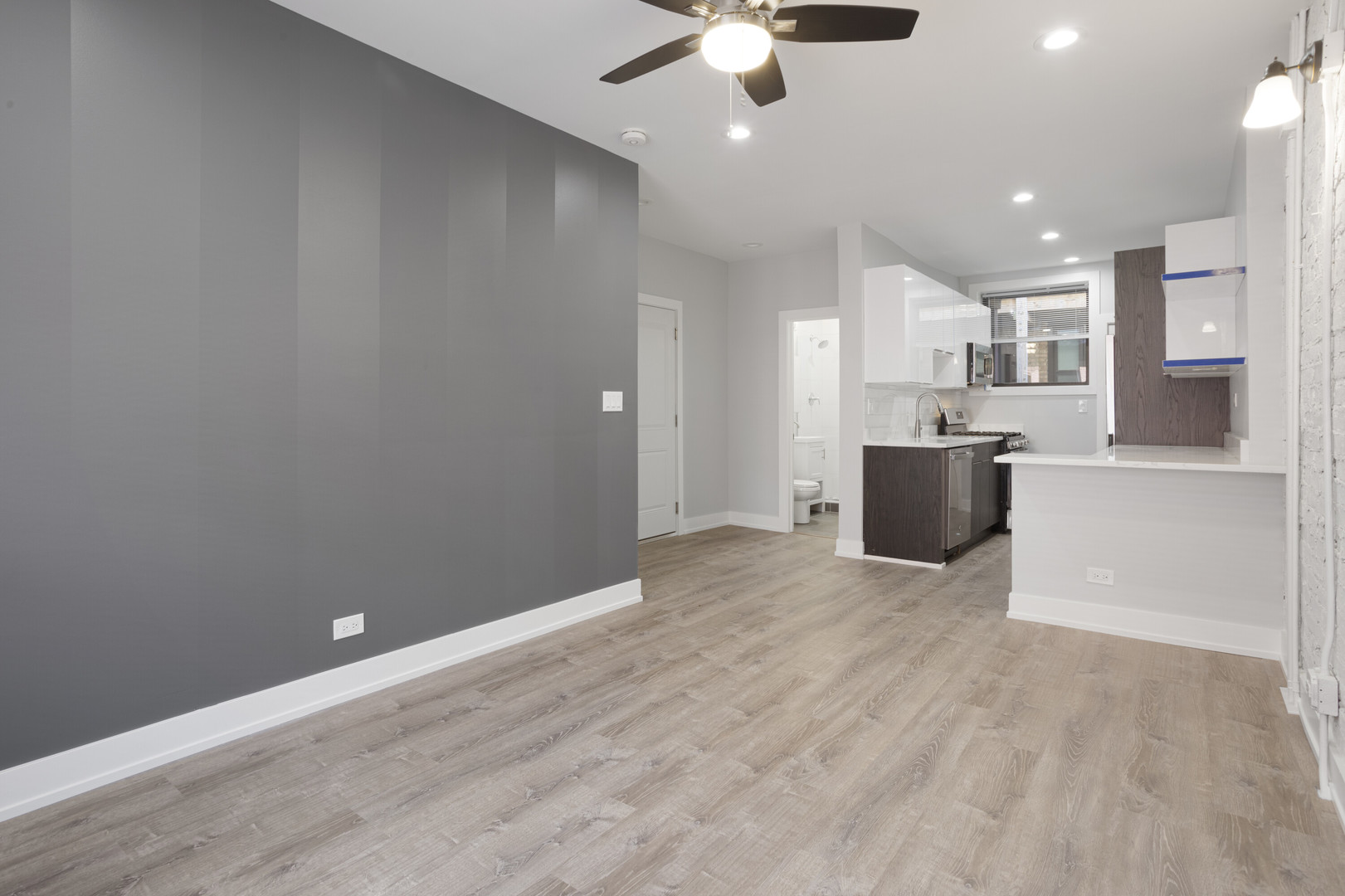 1708 West Juneway Terrace, Unit 2J Chicago, IL 60626 - Photo 4 of 13 an empty room with wooden floor and windows