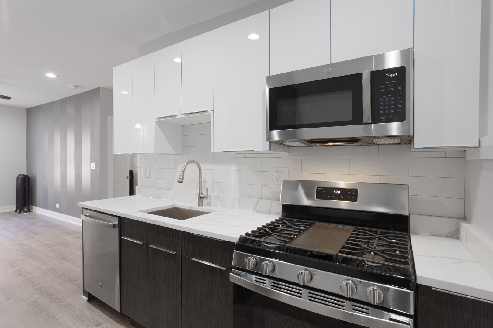 1708 West Juneway Terrace, Unit 2J Chicago, IL 60626 - Photo 5 of 13 a kitchen with stainless steel appliances a sink stove and microwave