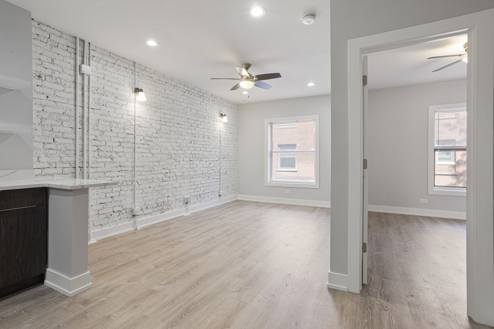 1708 West Juneway Terrace, Unit 2J Chicago, IL 60626 - Photo 6 of 13 wooden floor in an empty room with a window