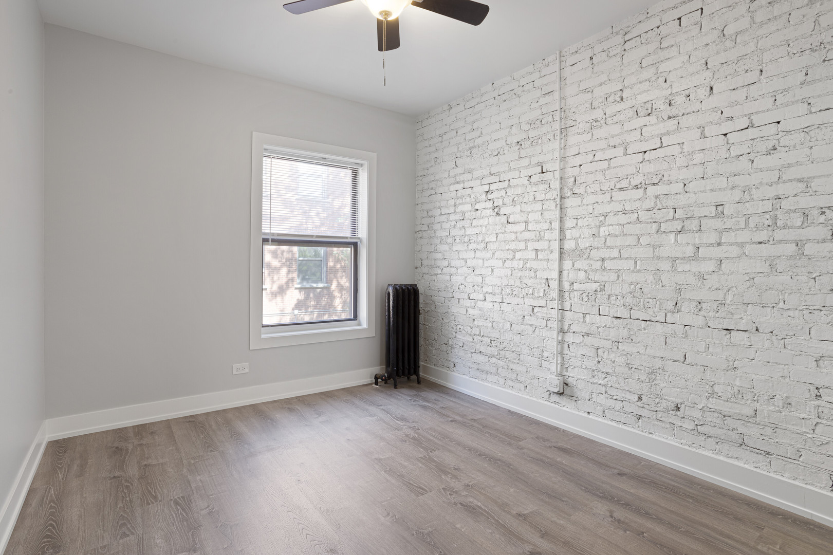 1708 West Juneway Terrace, Unit 2J Chicago, IL 60626 - Photo 7 of 13 an empty room with wooden floor and windows