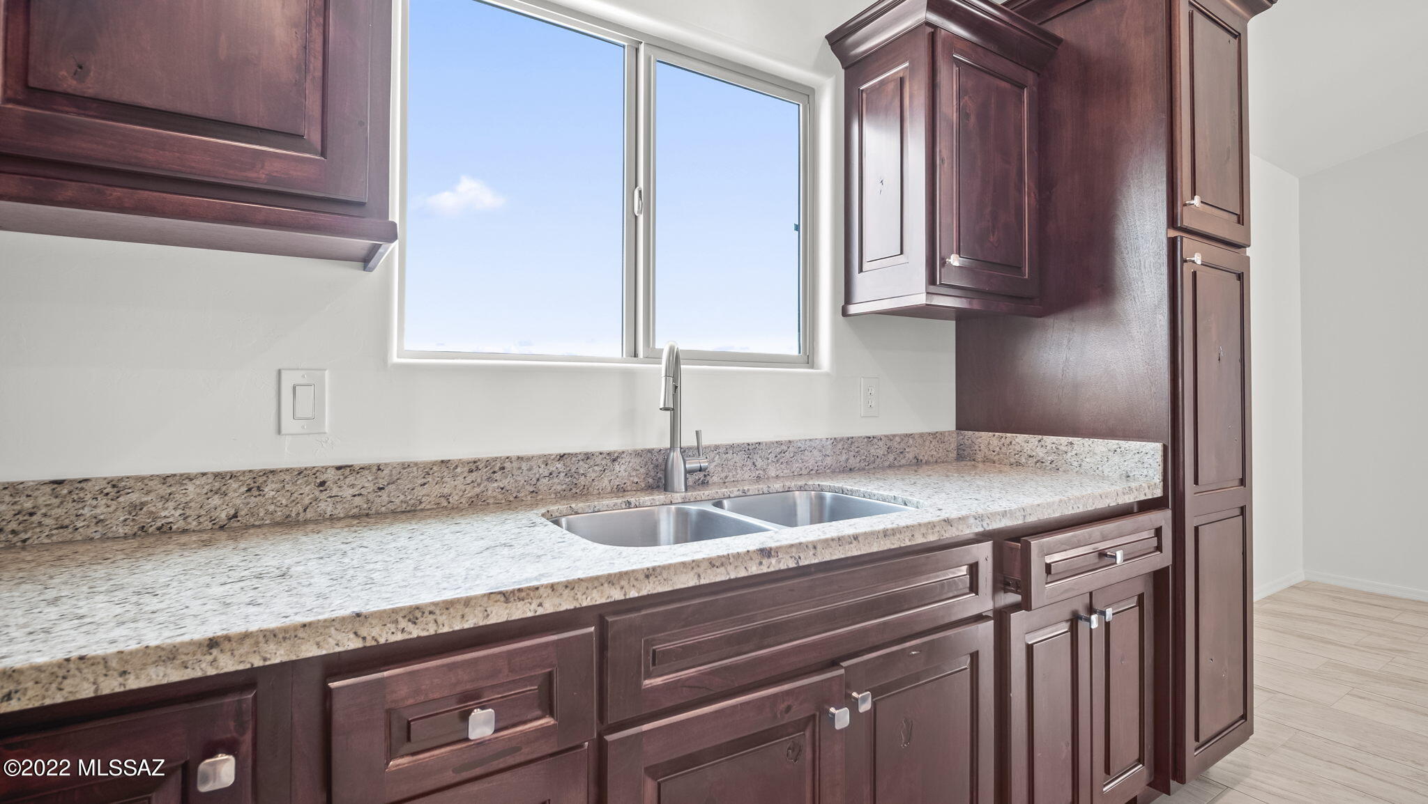 393 Quail Court Rio Rico, AZ 85648 - Photo 8 of 21 a kitchen with granite countertop a sink and cabinets